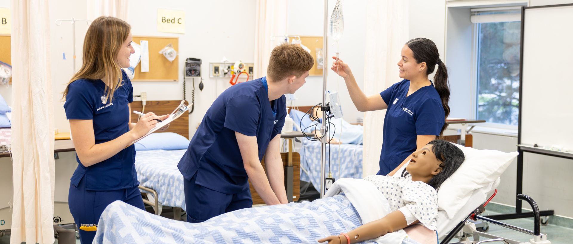 Nursing students working with simulation patient