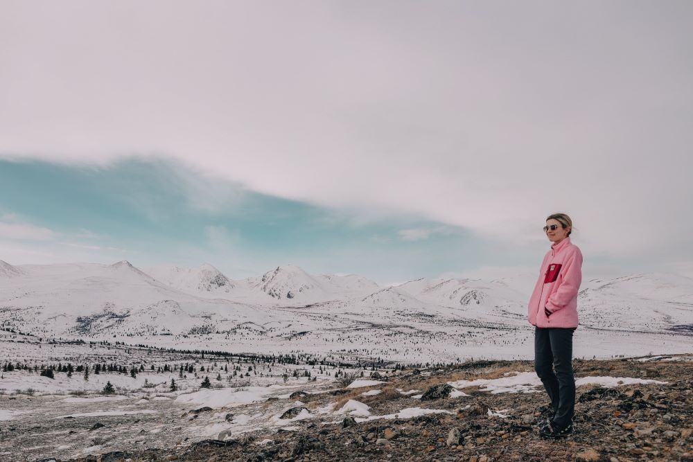 Nursing student standing in the open snowy landscape of the Yukon.